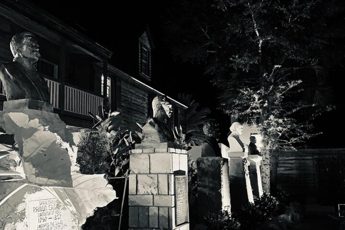 a black and white photo of a statue in front of a building