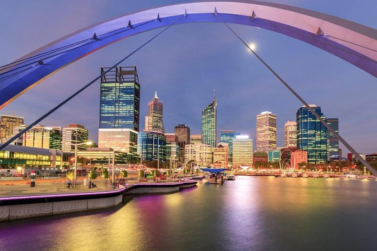 a bridge over a river with a city in the background