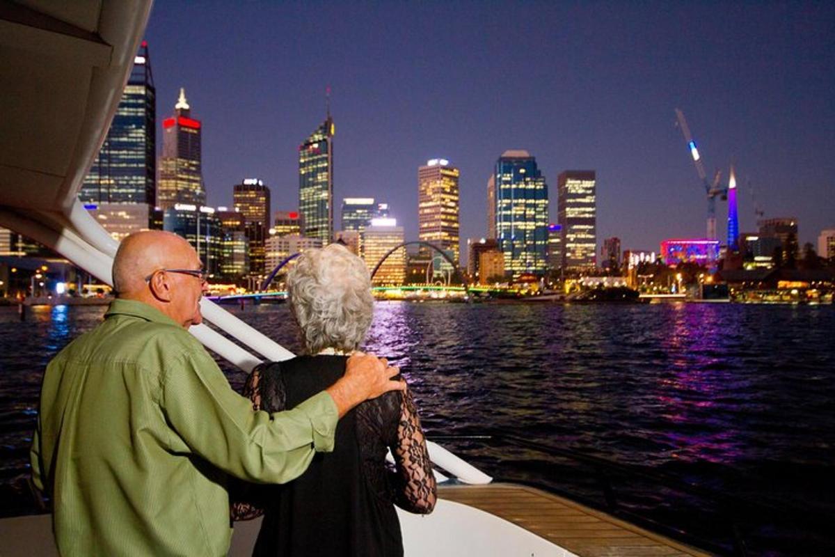 a man and woman on a boat in the water with a city