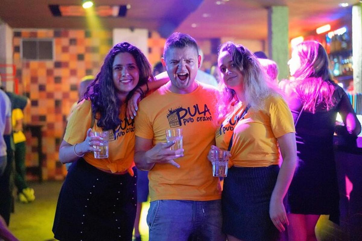 a group of people standing in a party with drinks