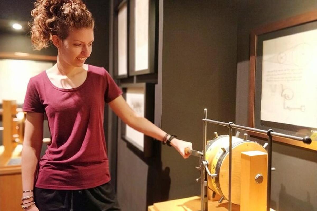 a woman standing in front of a metal apparatus
