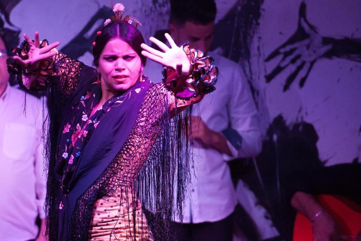 a woman standing on a stage with her hands up