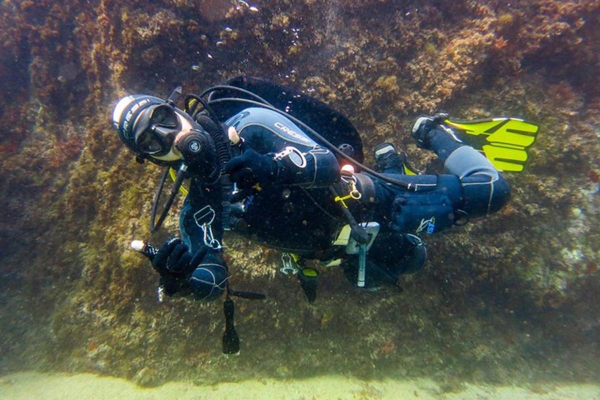 a person in a diving suit laying in the water