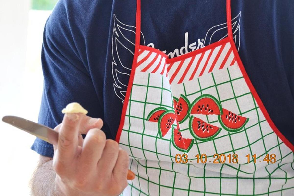 a person with an apron with a piece of fruit on it