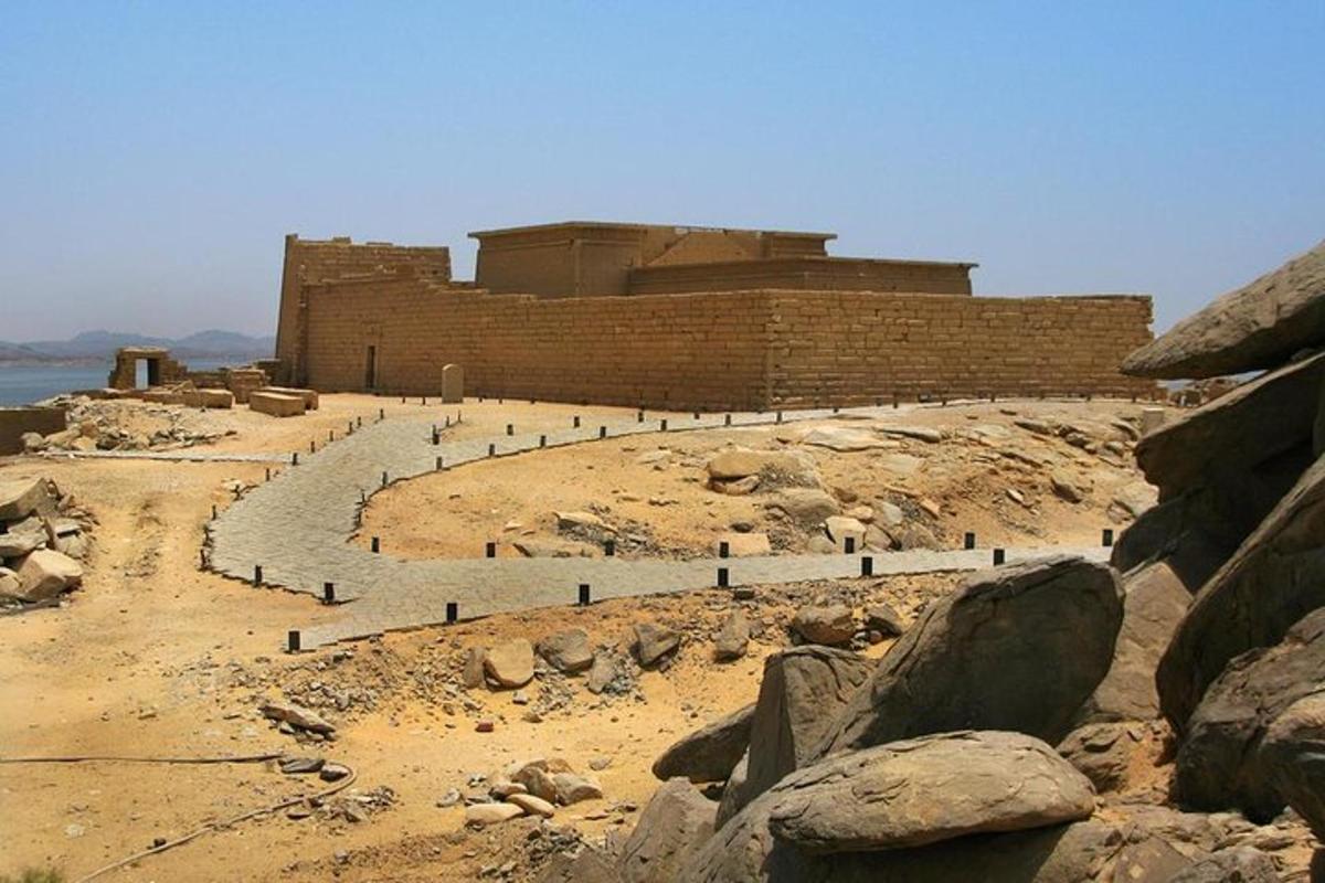 a building on top of a hill with rocks