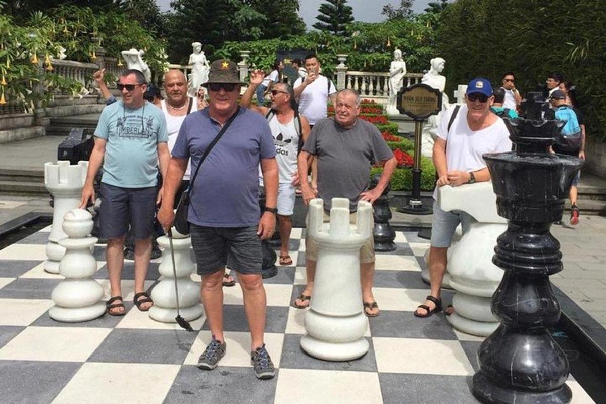 a group of people standing on a giant chessboard