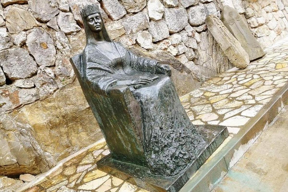 a statue of a man sitting in a chair