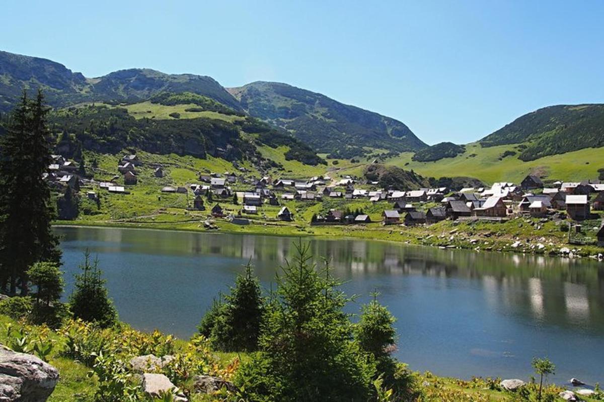 Un pequeño pueblo en un valle con un lago.
