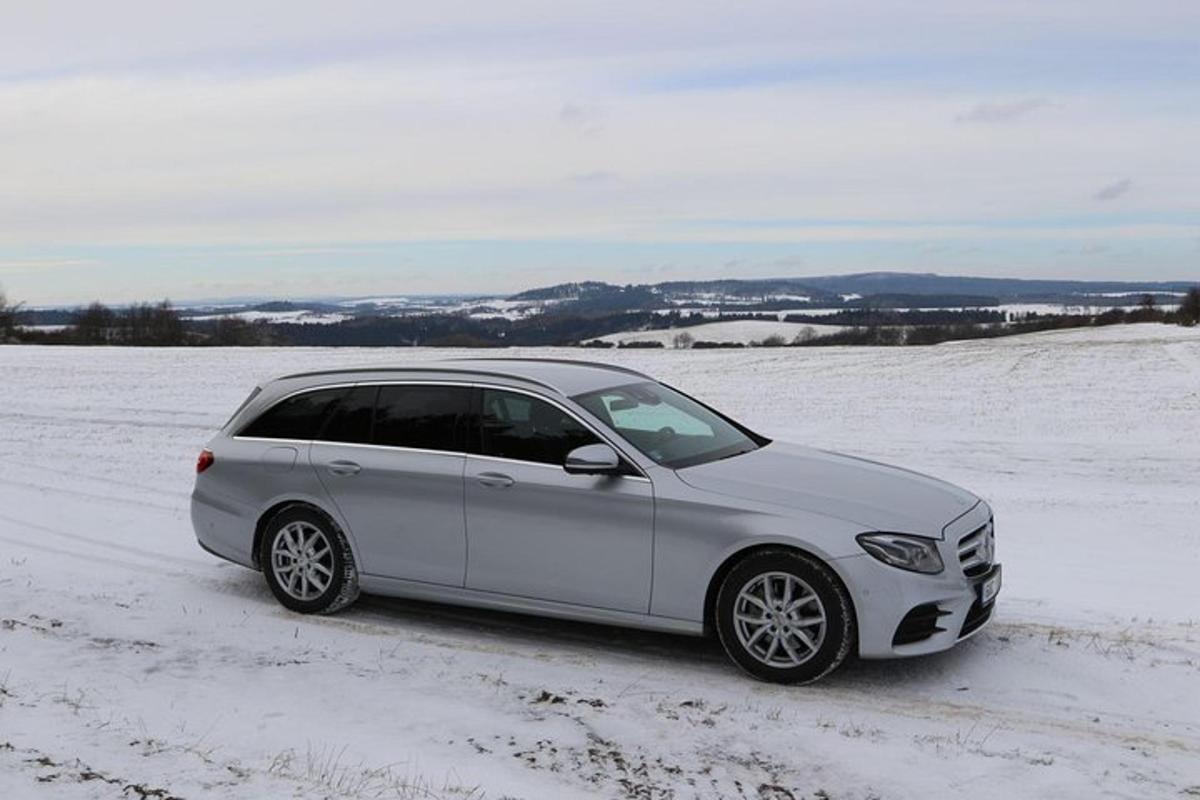 a silver car parked in a snow covered field