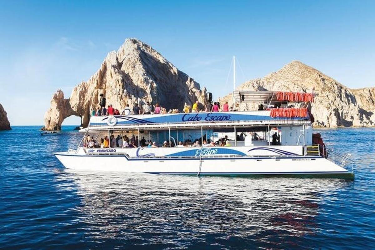 a ferry boat in the water with rocks in the background