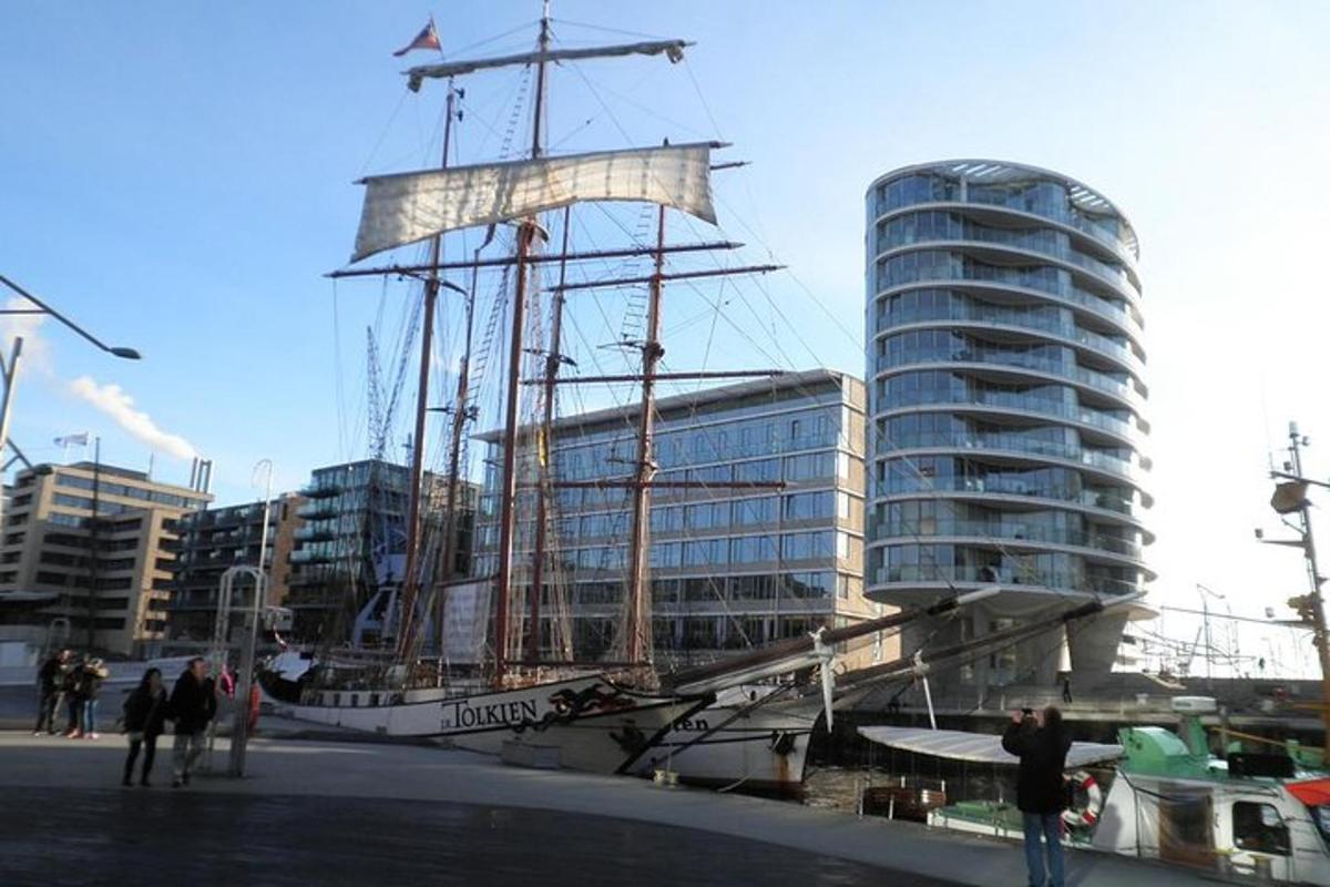 a tall ship docked in front of a building
