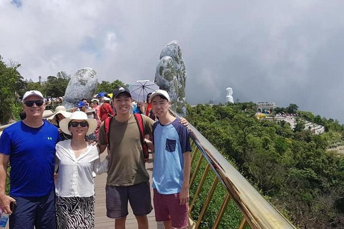 a group of people posing for a picture on a bridge