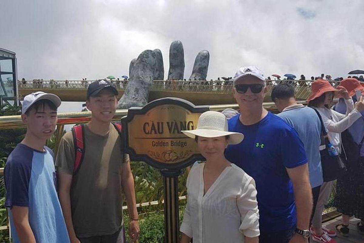 a group of people standing in front of a sign