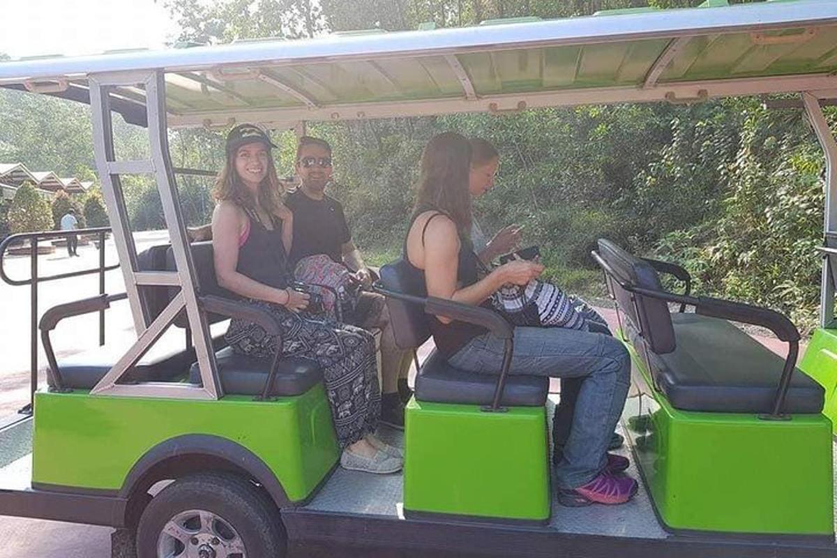 a group of people sitting in a golf cart