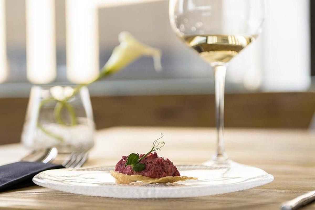 a plate of food and a glass of wine on a table