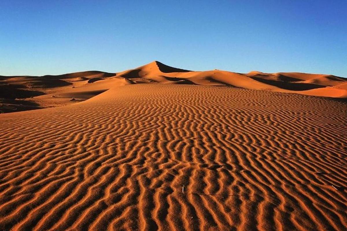 un desierto con dunas de arena y un cielo azul