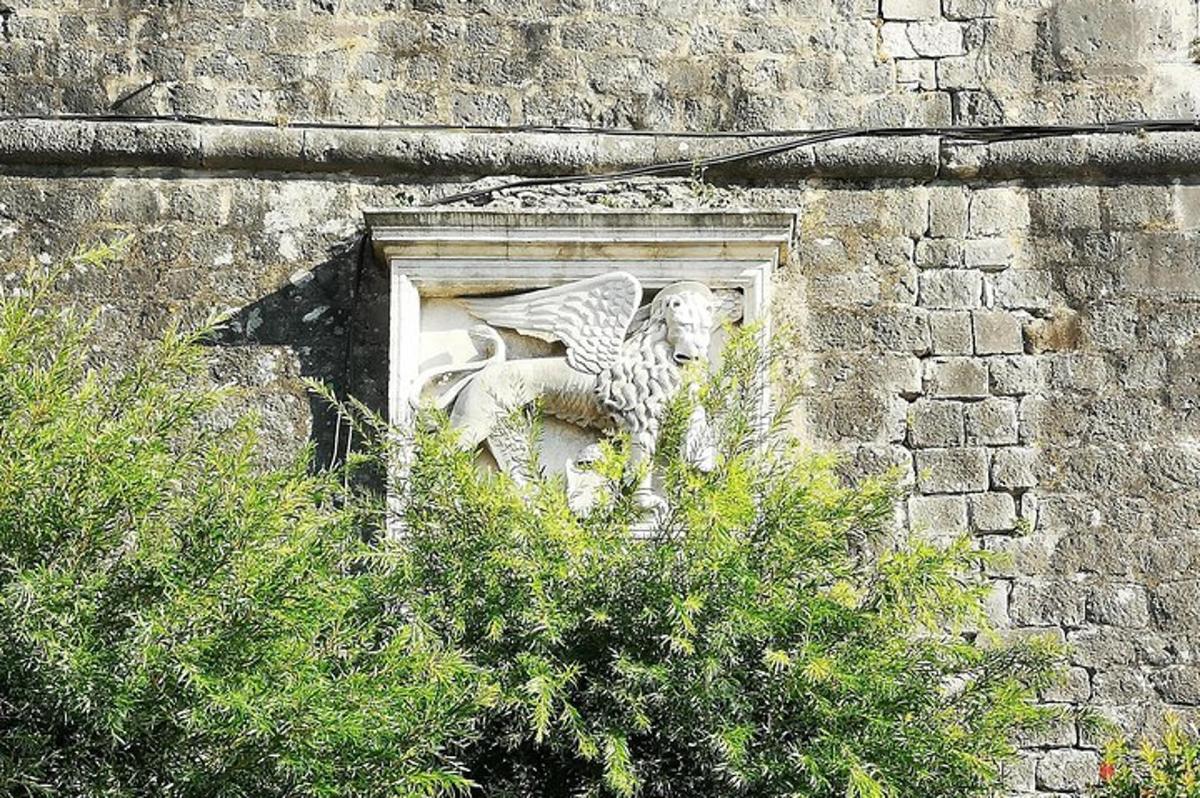a stone gargoyle on the side of a building