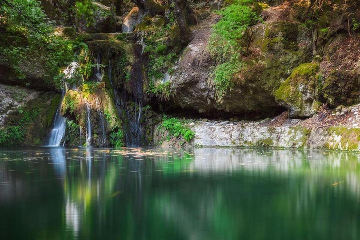 a waterfall in the middle of a body of water