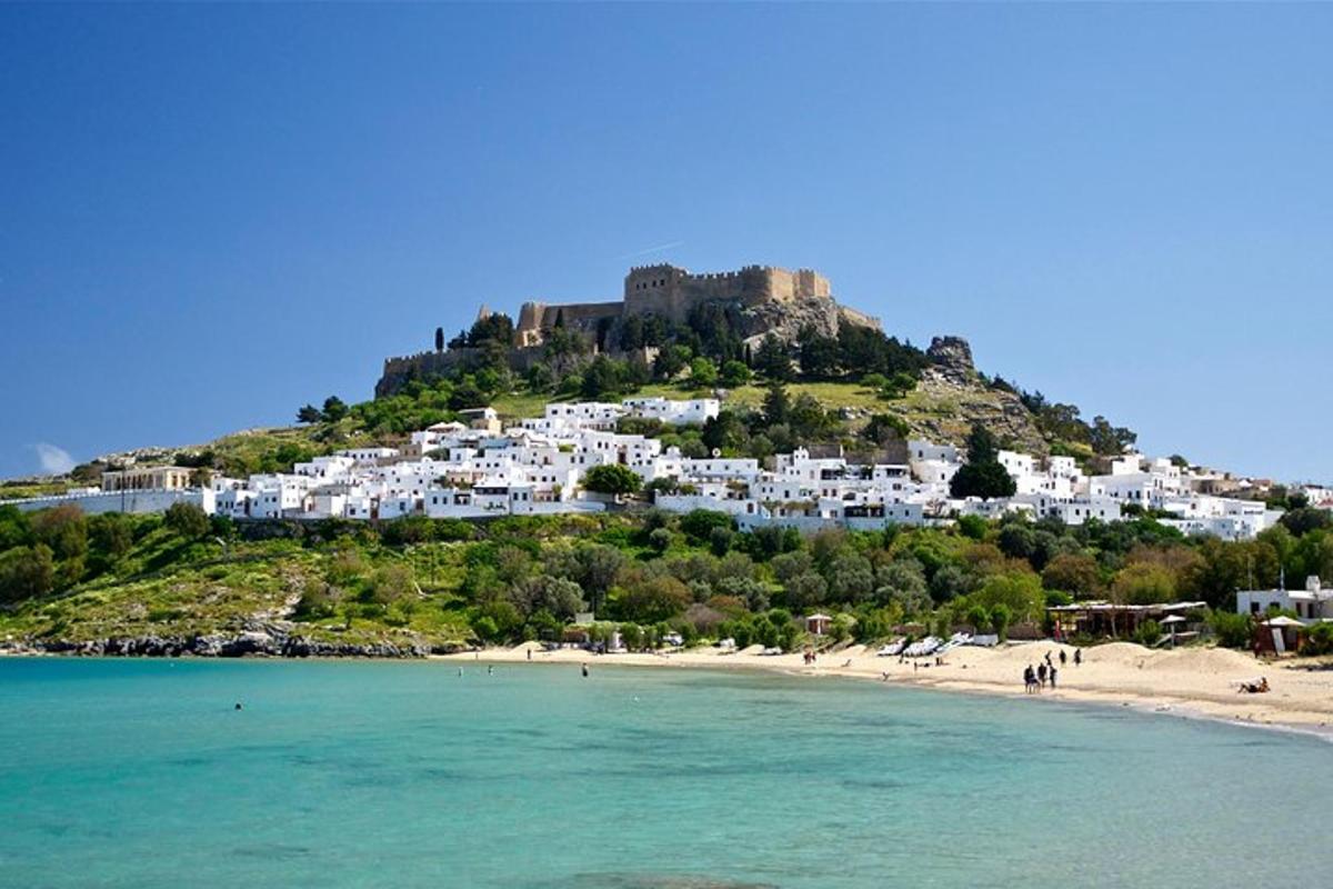 a view of a beach with a castle on a hill