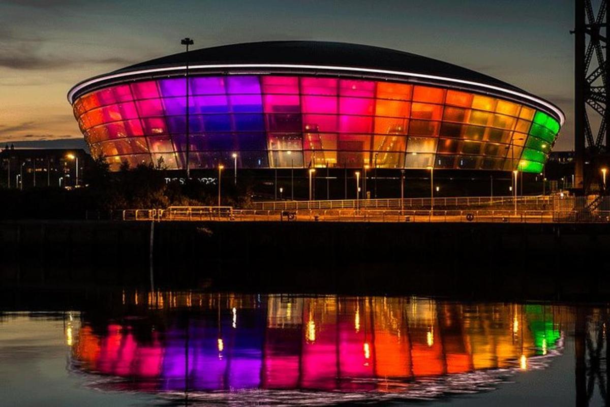 a large circular building with colorful lights on it