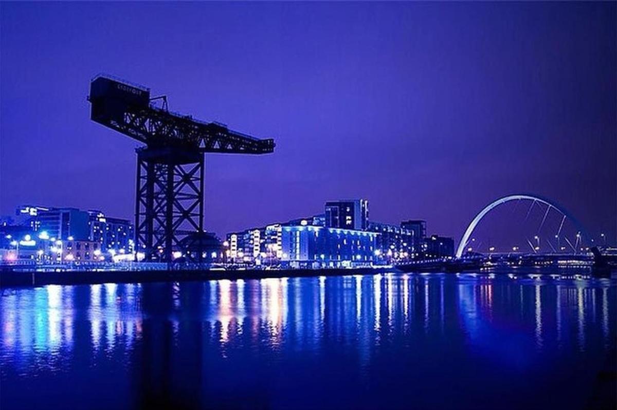 a view of a city at night with a crane