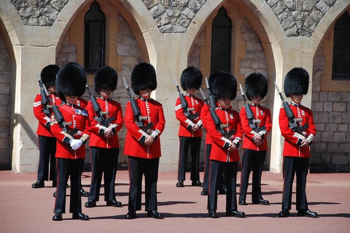 a group of soldiers in red uniforms standing in front of a building