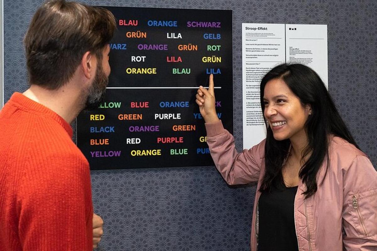 a woman pointing at a poster with a man