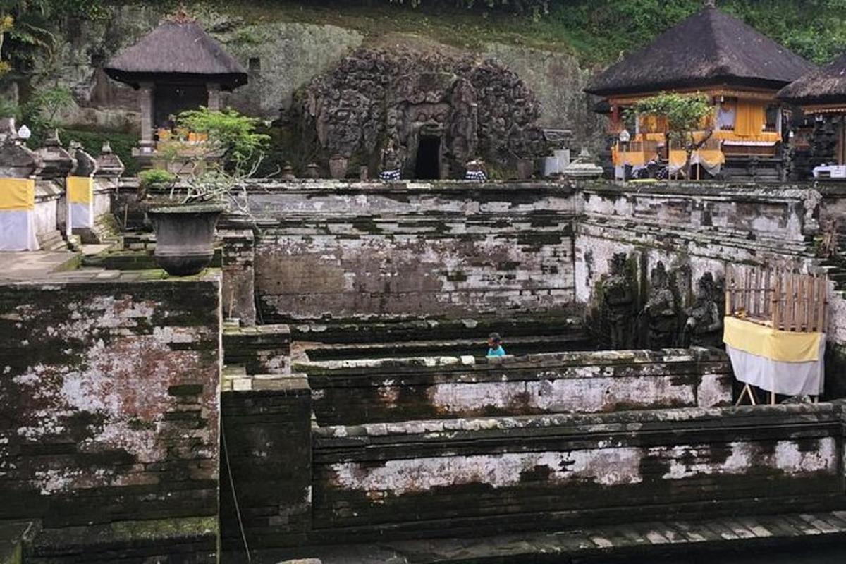 an old stone wall with a person sitting on it