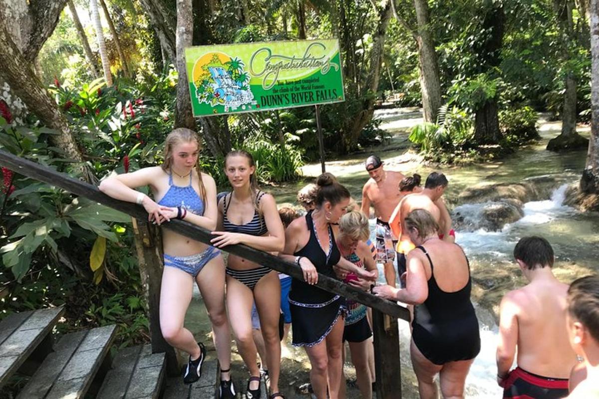 a group of women in bikinis are crossing a river