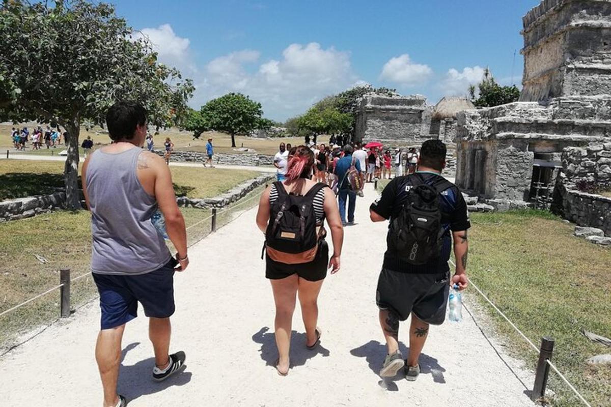 a group of people walking around the ruins