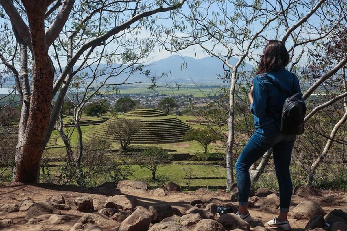 a woman standing on rocks looking at a park
