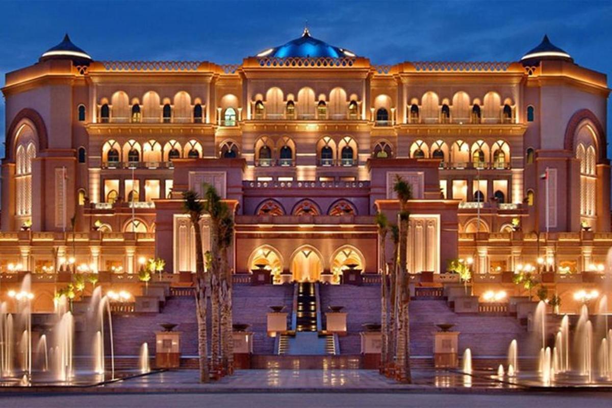 a large building with palm trees in front of it