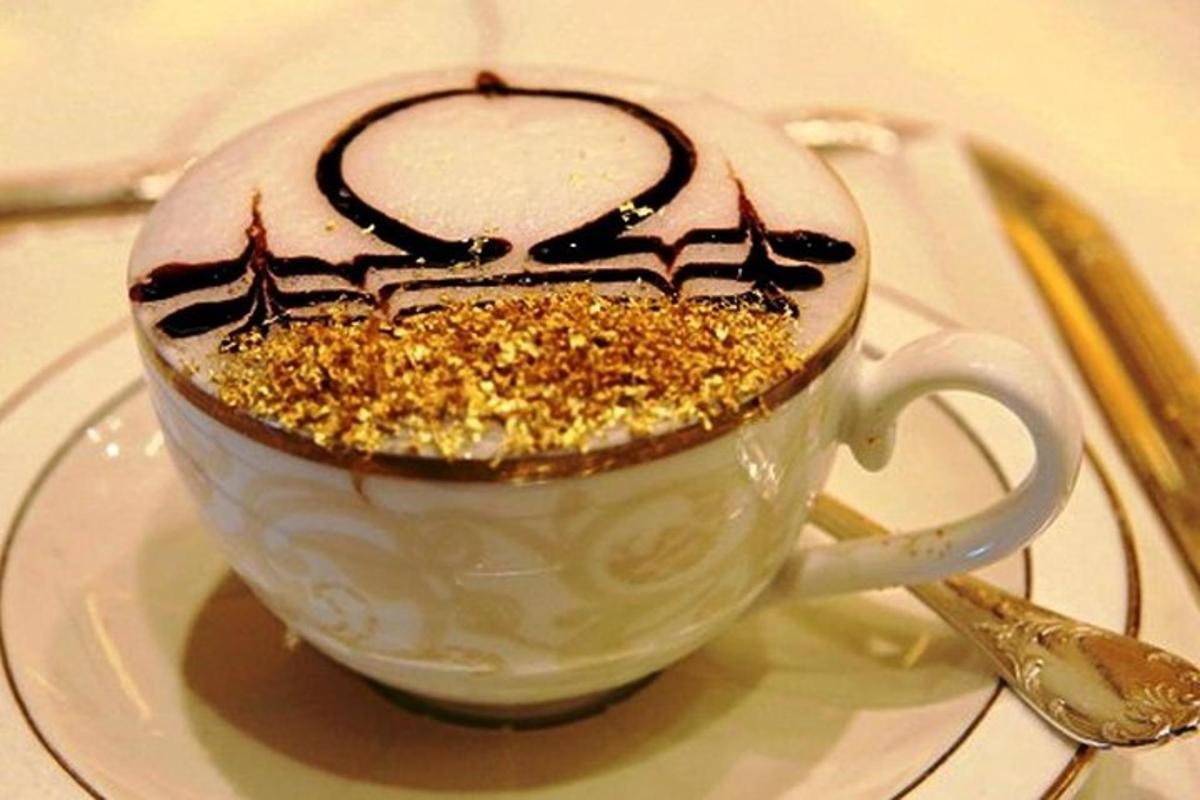 a white cup with a dessert in it on a plate