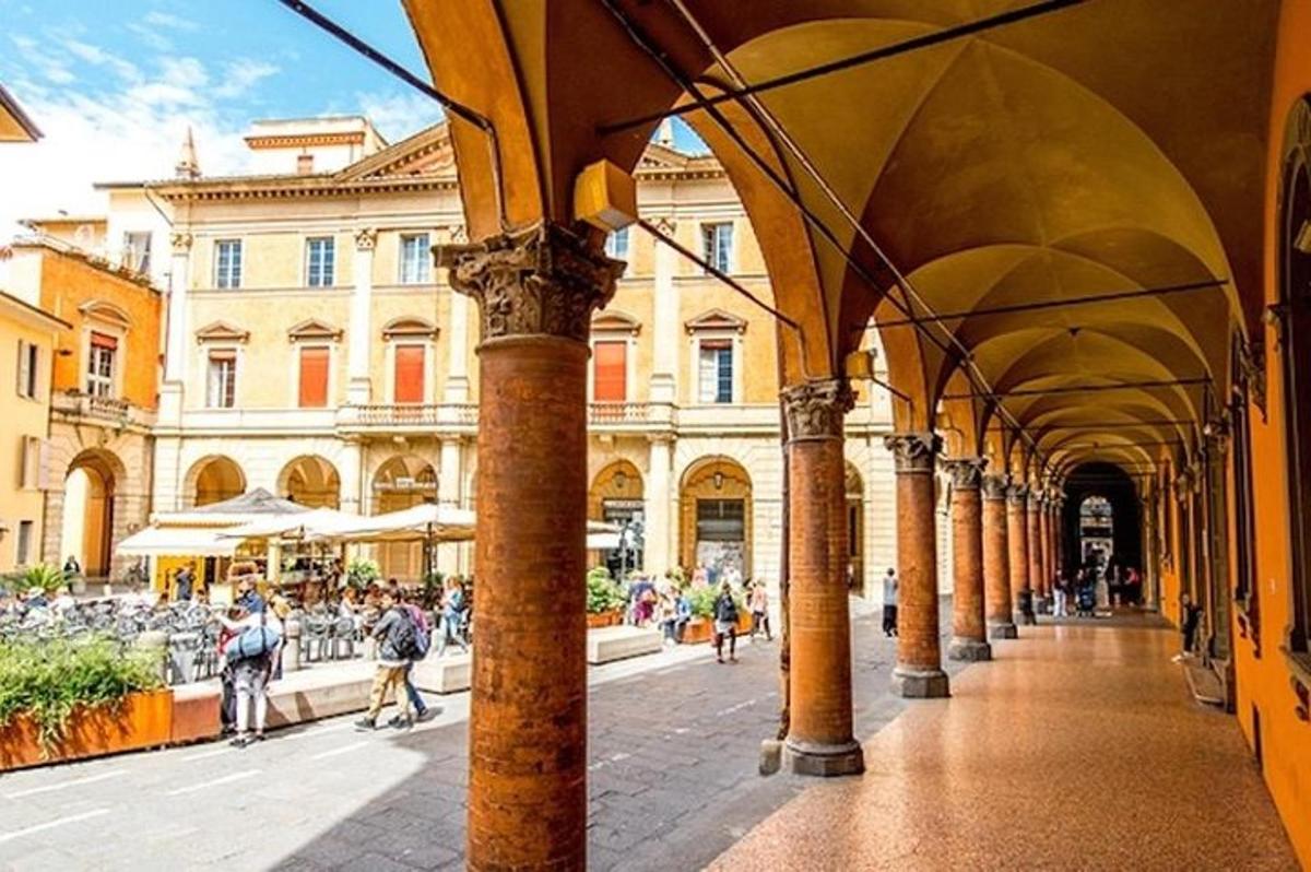 um edifício com colunas e pessoas caminhando em uma rua