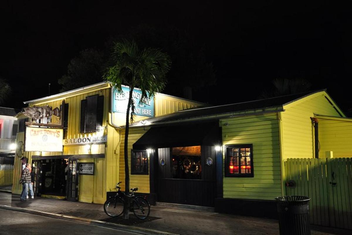a yellow building with a palm tree in front of it