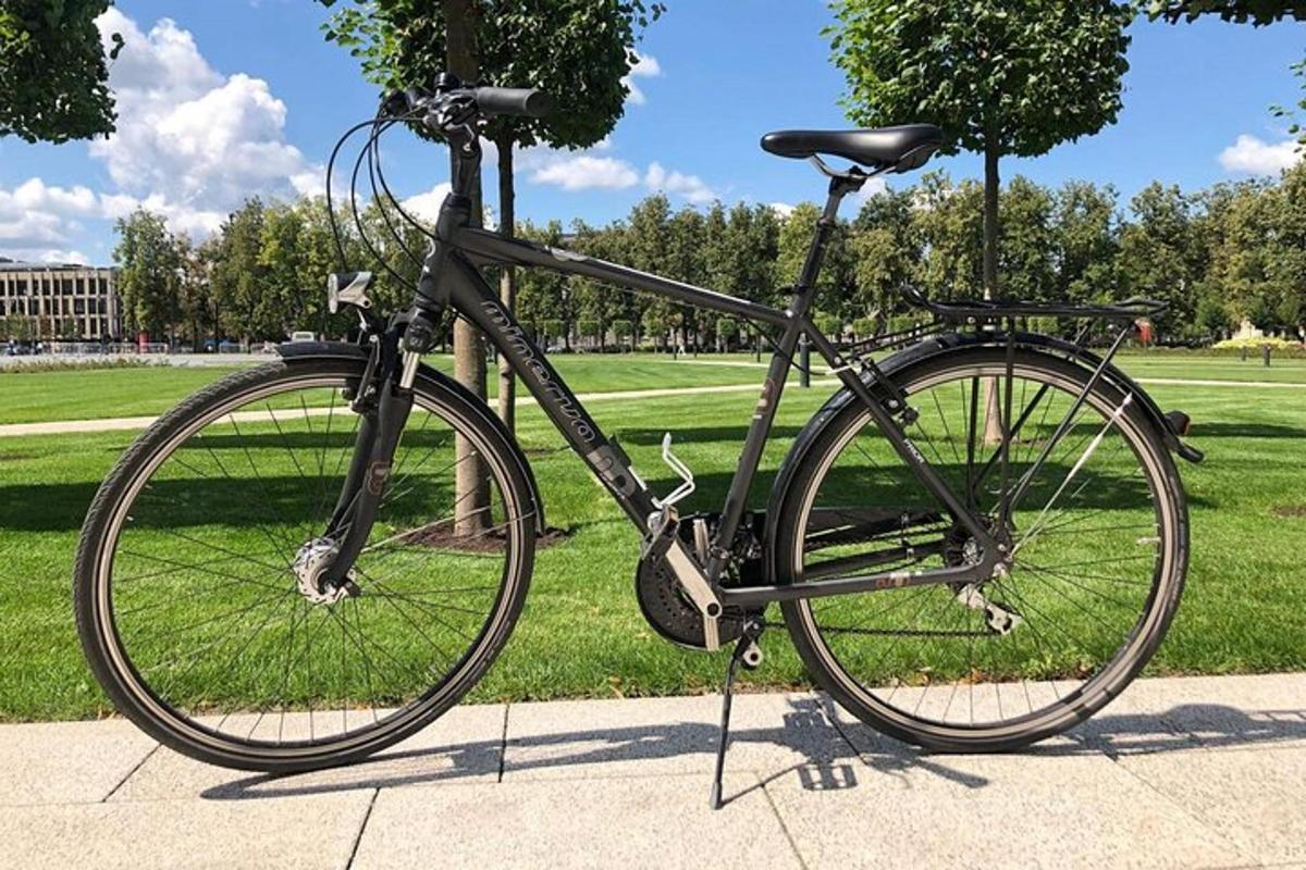 a bike parked on a sidewalk in a park