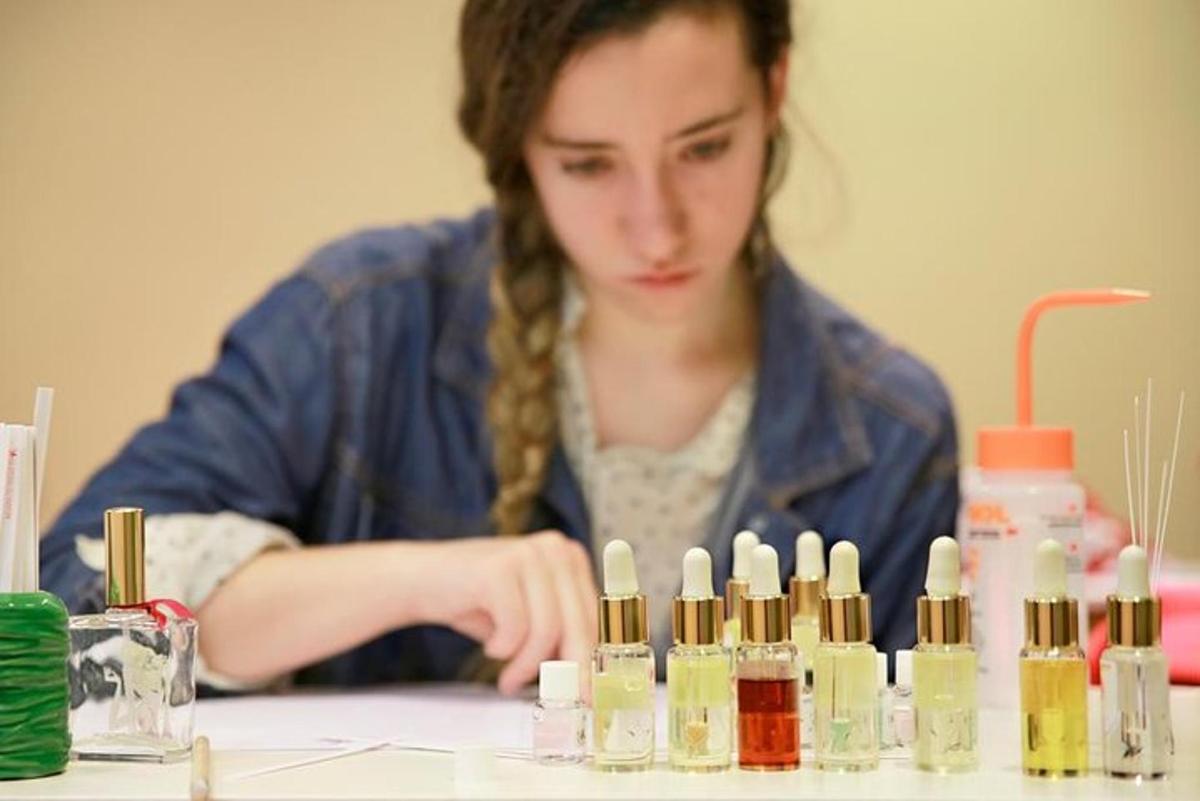 a woman sitting at a table with a bunch of bottles
