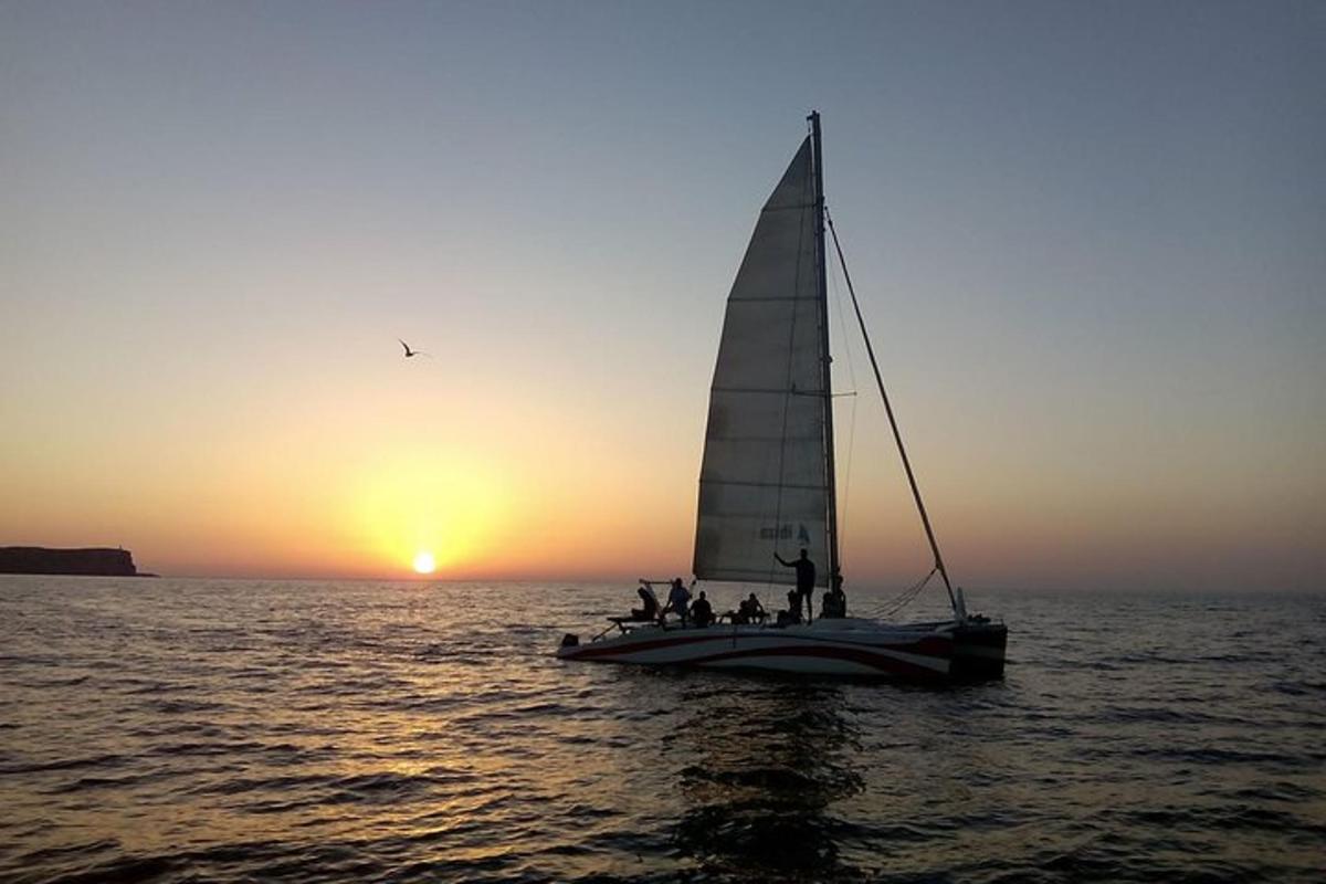 a group of people on a sail boat in the ocean