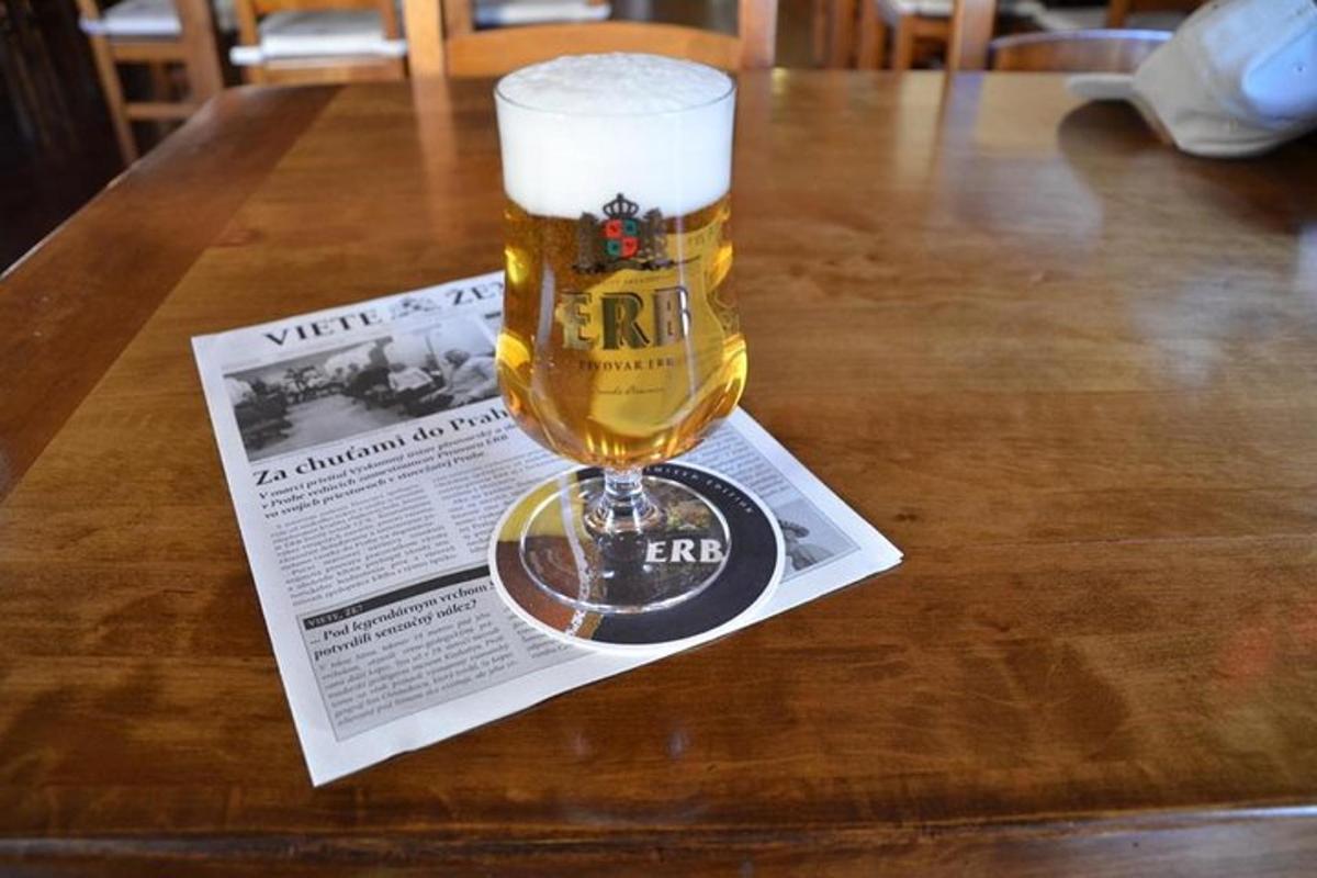 a glass of beer sitting on top of a table