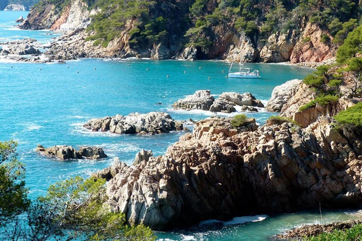 a boat in a body of water with rocks