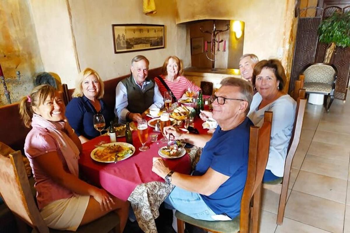 a group of people sitting around a table eating food