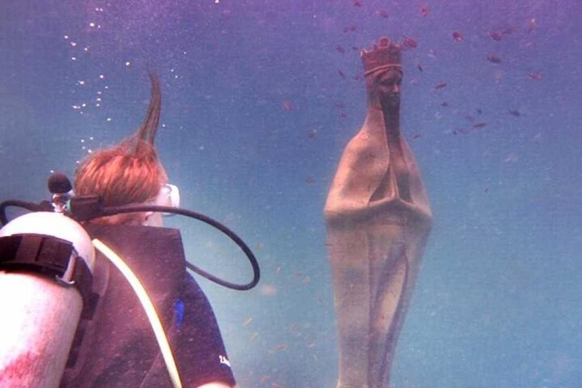 a person taking a picture of a man in the water