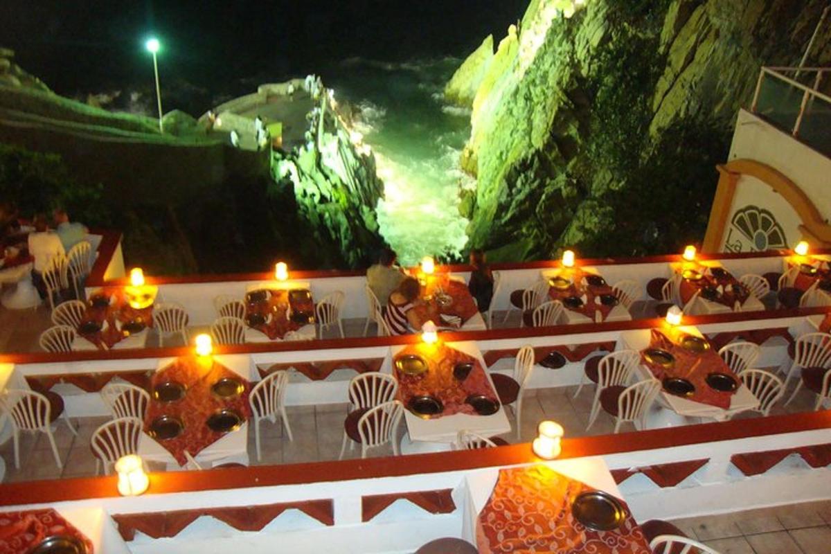 a table with candles and chairs and lights on it