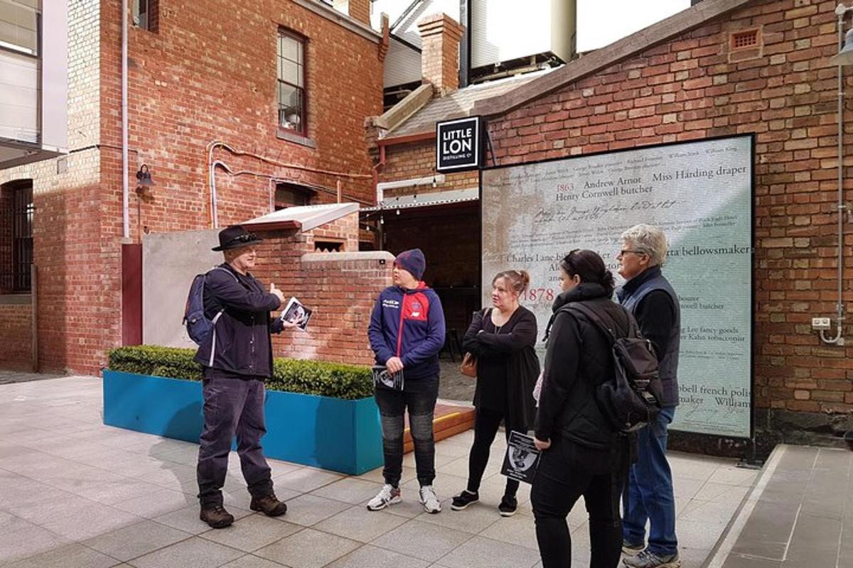 a group of people standing outside of a brick building