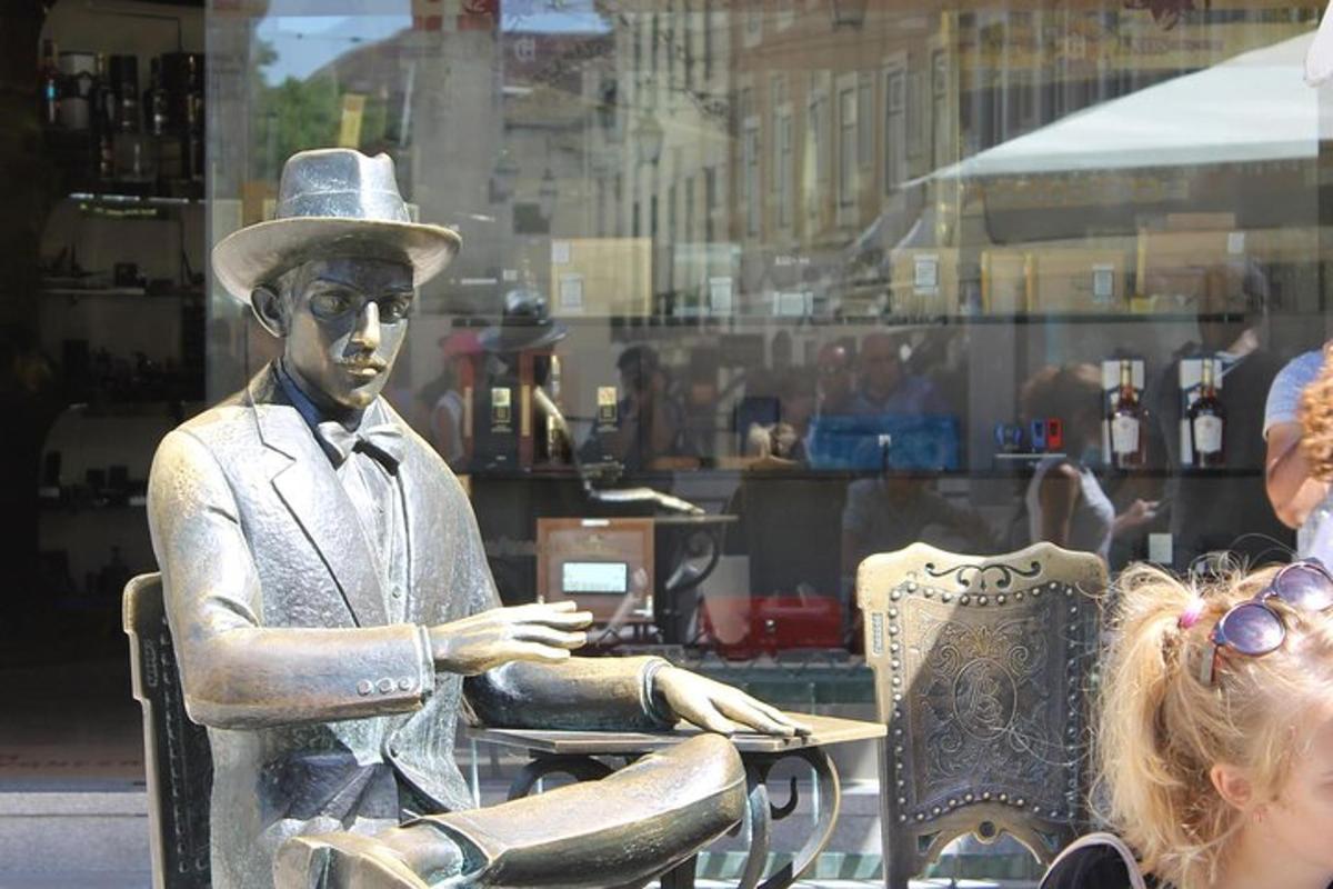 una statua di un uomo con un cappello seduto a un tavolo