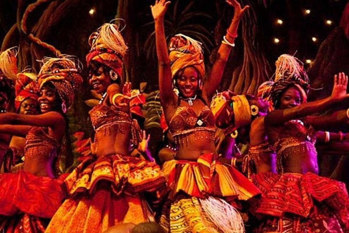 a group of women in costumes on a stage