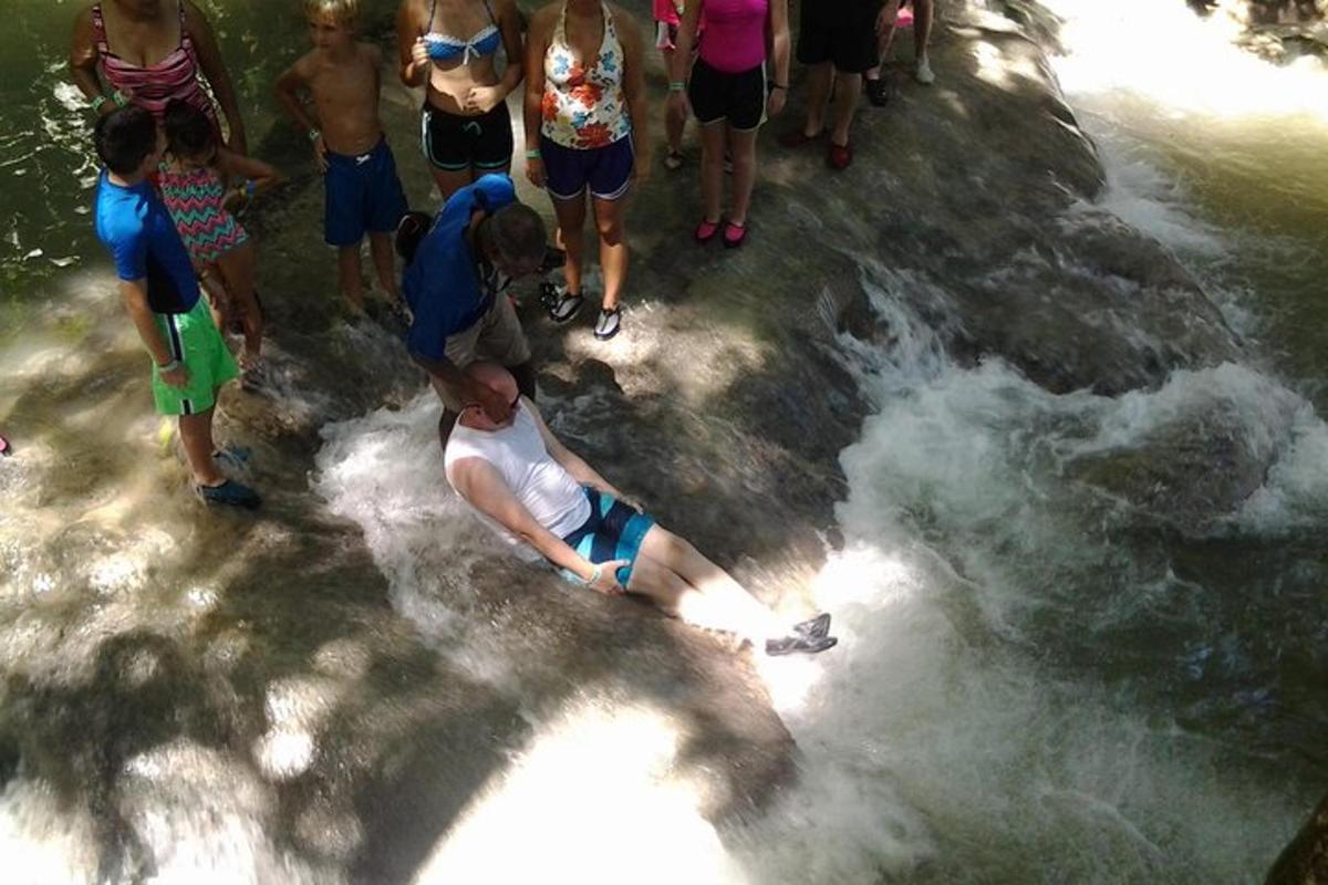 a group of people looking at a man in the water