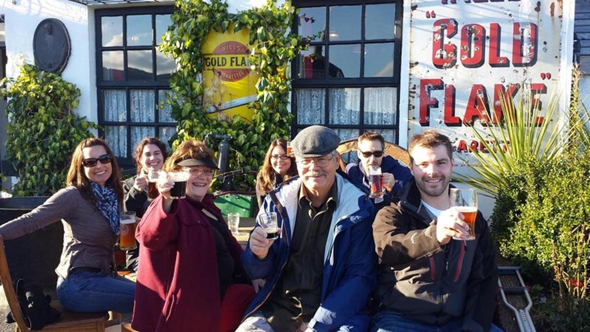 a group of people posing for a picture while drinking wine