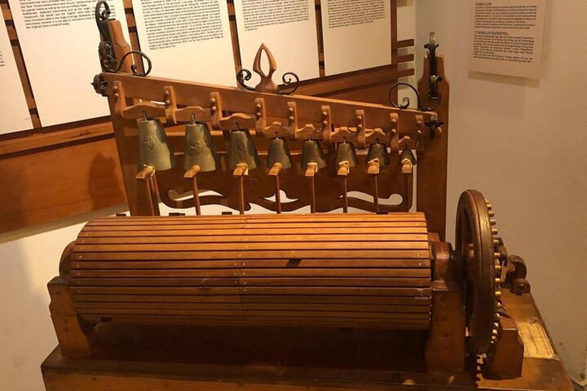 a bench in a museum with bells on it