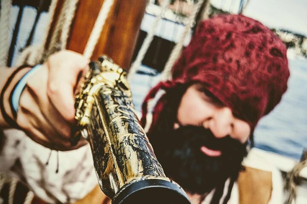 un hombre con barba sosteniendo un saxofón